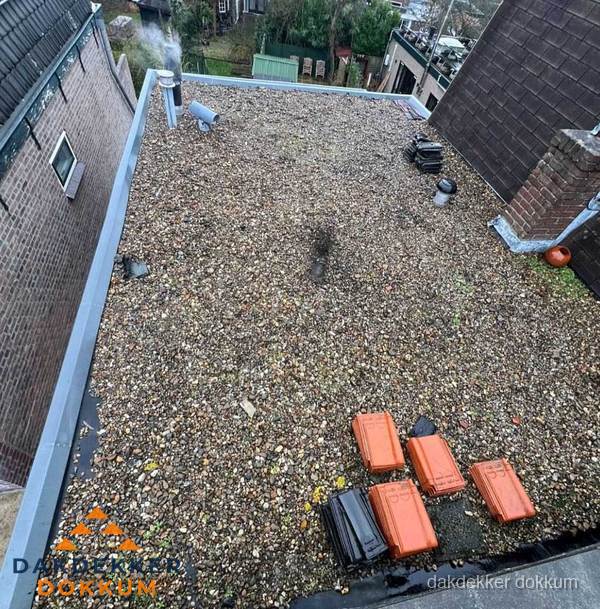 Plat dak met grindballast en dakdoorvoeren in Dokkum